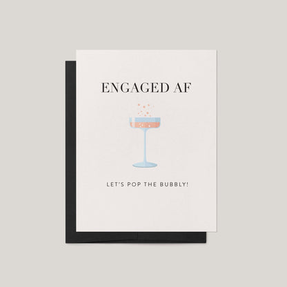 Greeting card with 'ENGAGED AF' text and champagne glass illustration on a beige background
