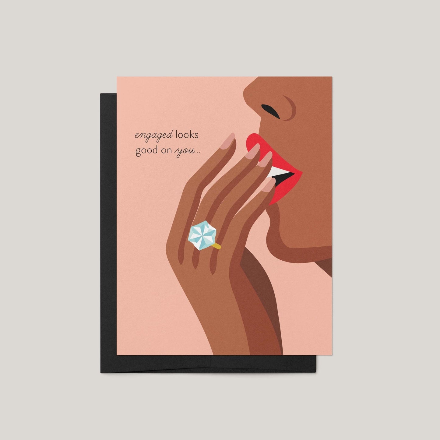 Greeting card with illustration of a hand wearing a ring and text 'engaged looks good on you' on a pink background.