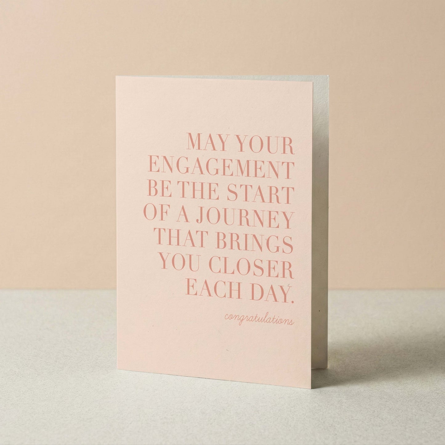 Greeting card with pink text on a beige background