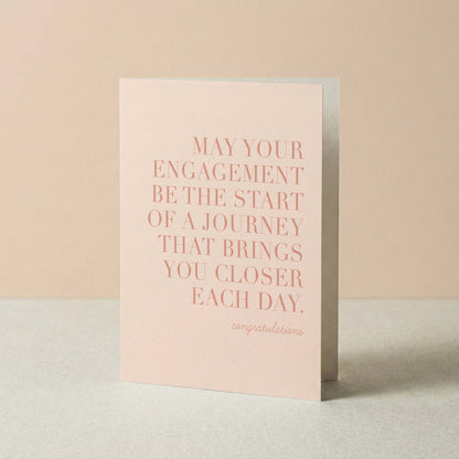Greeting card with pink text on a beige background