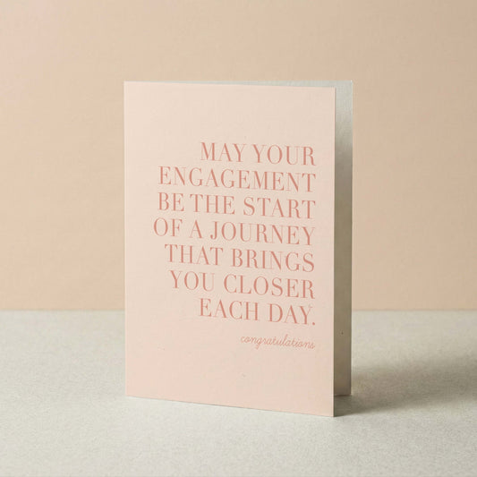 Greeting card with pink text on a beige background
