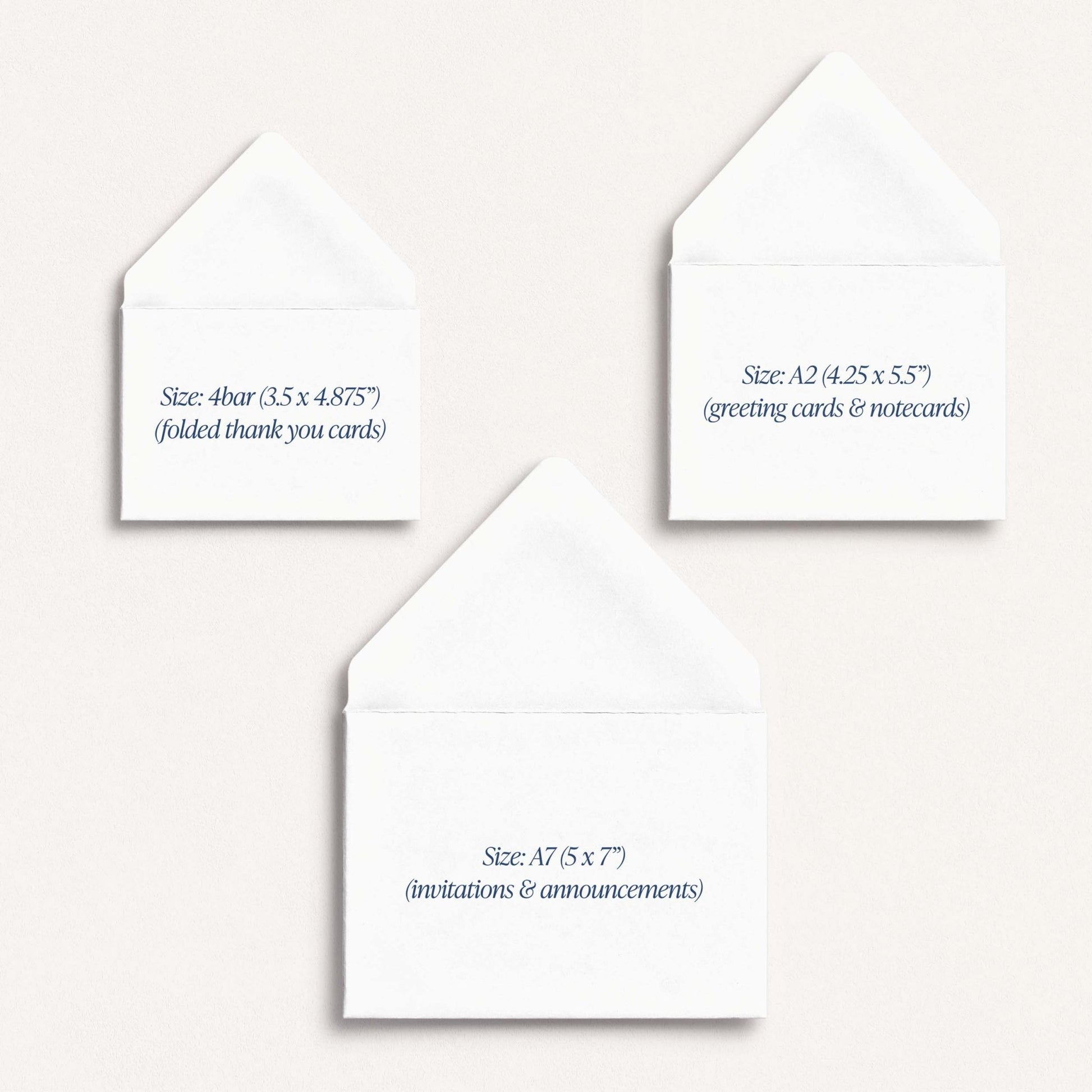 Three white greeting cards with text indicating their sizes on a stone background