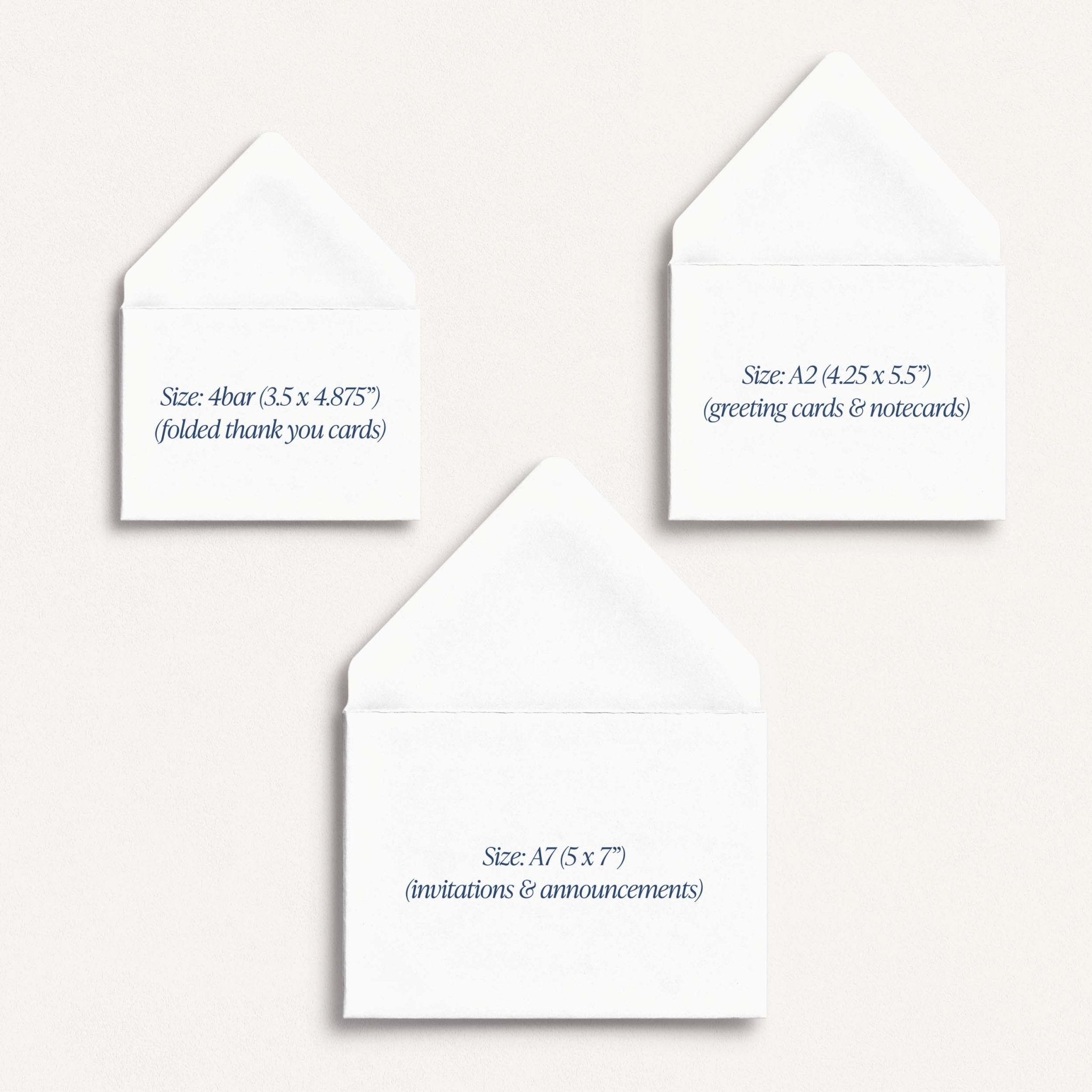 Three white greeting cards with text indicating their sizes on a stone background