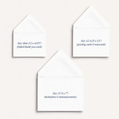 Three white greeting cards with text indicating their sizes on a stone background