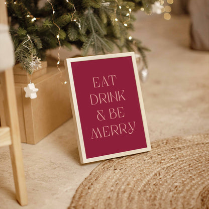 Eat Drink & Be Merry festive typography art print styled on the floor near holiday decor