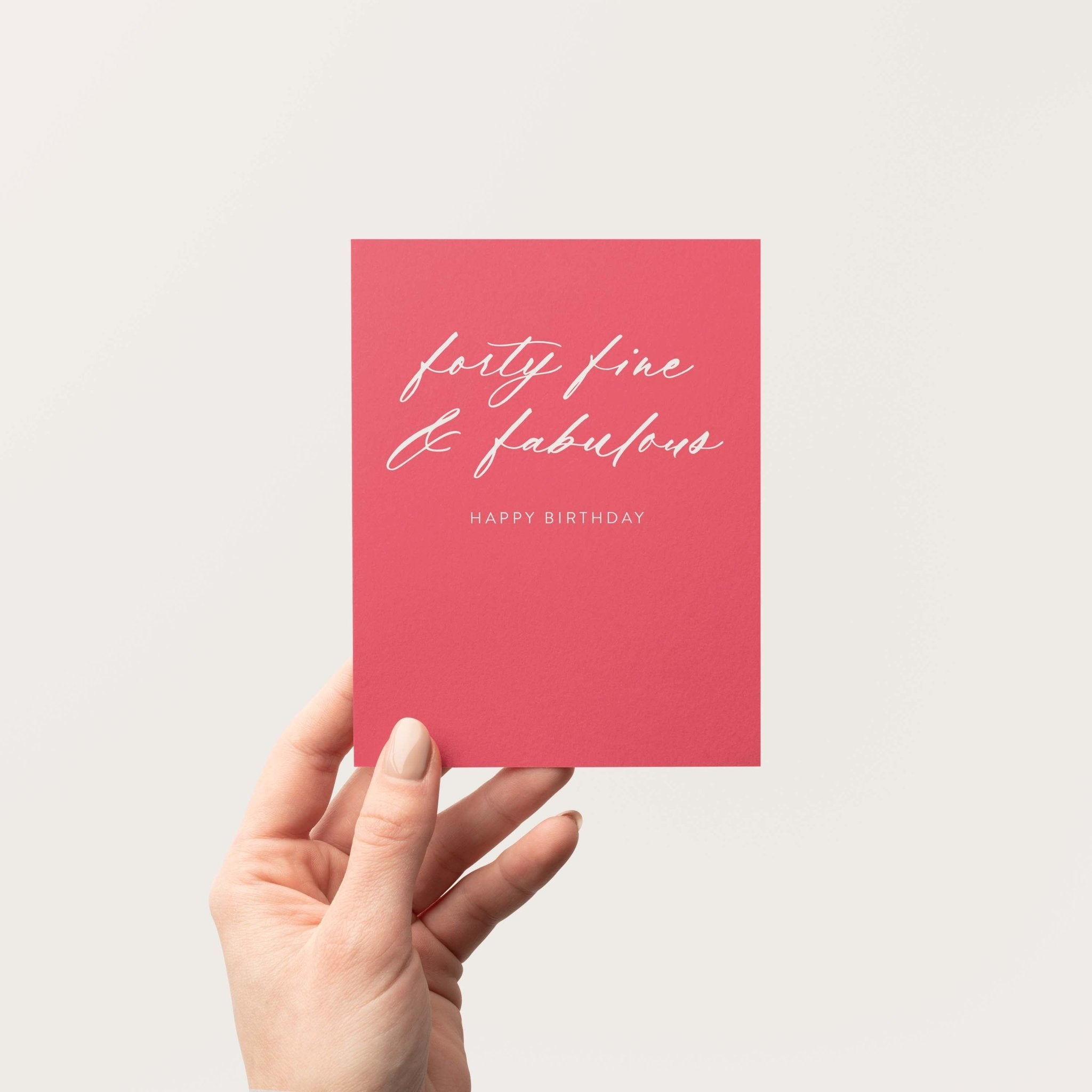 Forty Fine + Fab birthday greeting card by Blú Rose held in hand against a neutral off-white background