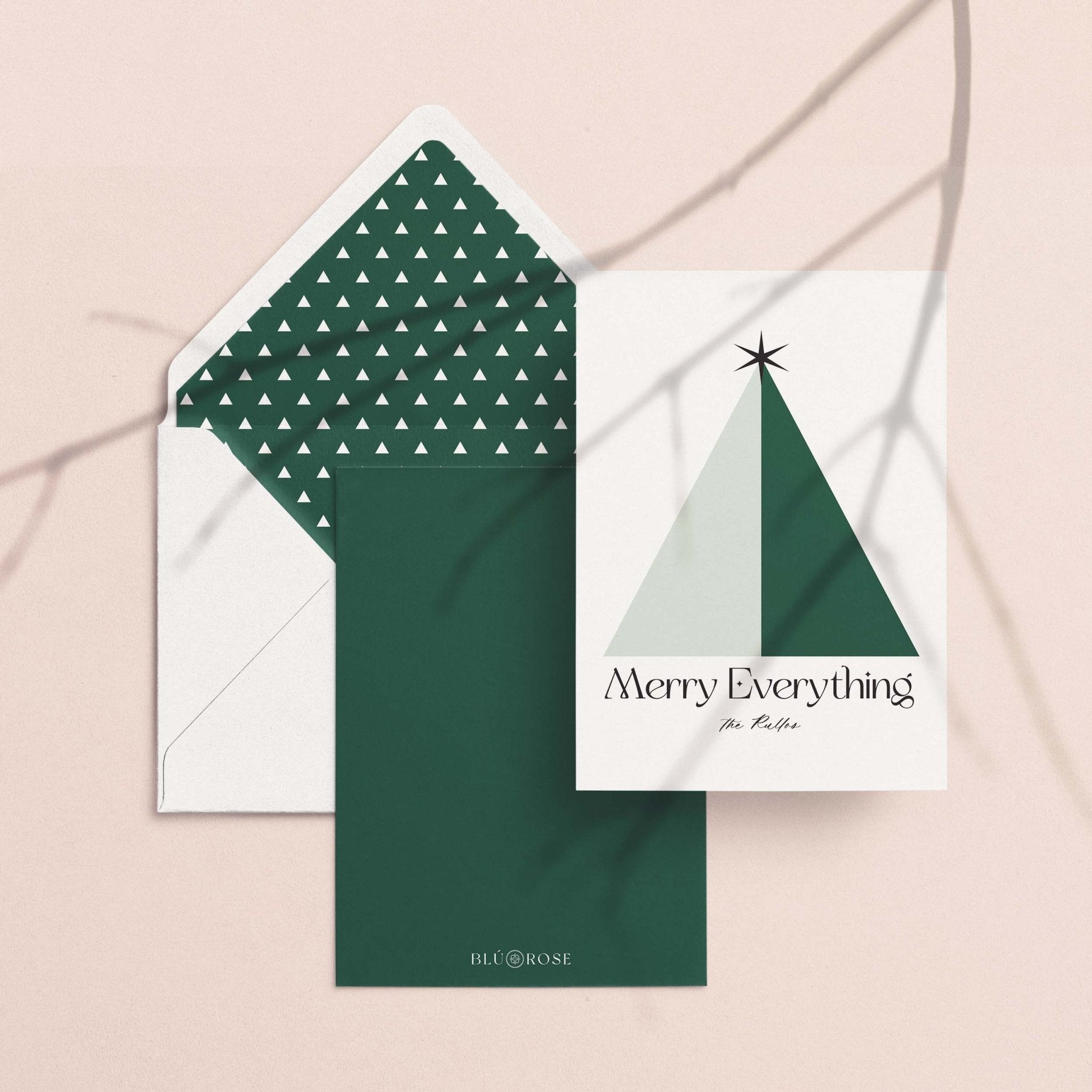 Geo Tree card with its forest green dotted envelope liner styled on a blush backdrop