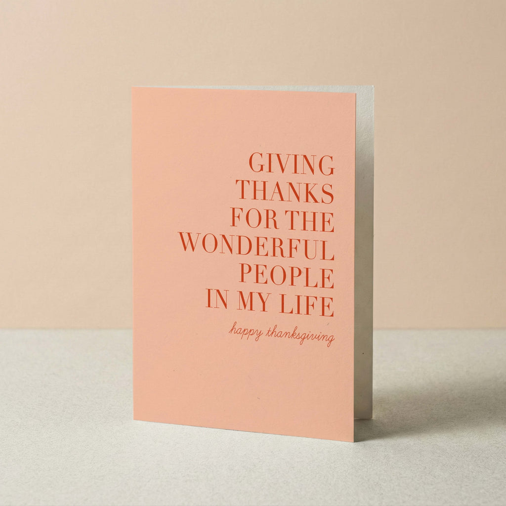 Giving Thanks Happy Thanksgiving card by Blú Rose standing upright, blush card with terracotta typography on a neutral background