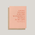 Giving Thanks Thanksgiving greeting card by Blú Rose, blush card with terracotta serif gratitude message, shown with kraft envelope