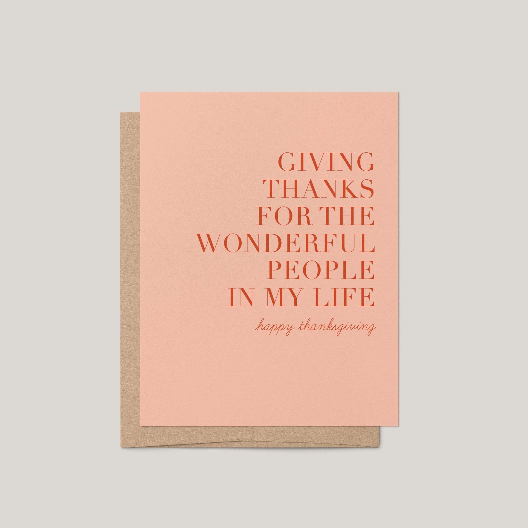 Giving Thanks Thanksgiving greeting card by Blú Rose, blush card with terracotta serif gratitude message, shown with kraft envelope