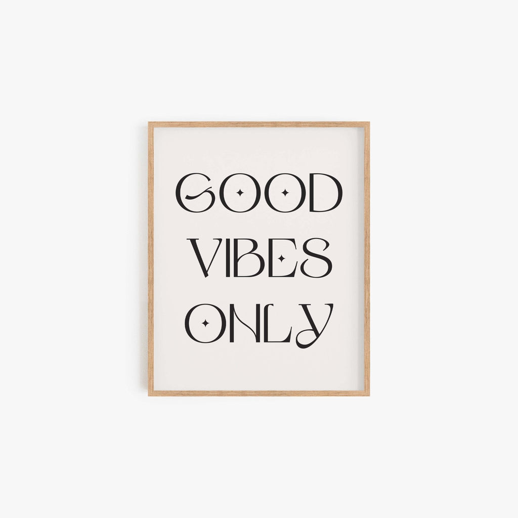 Good Vibes Only typography art print in black lettering on off-white background in natural wood frame