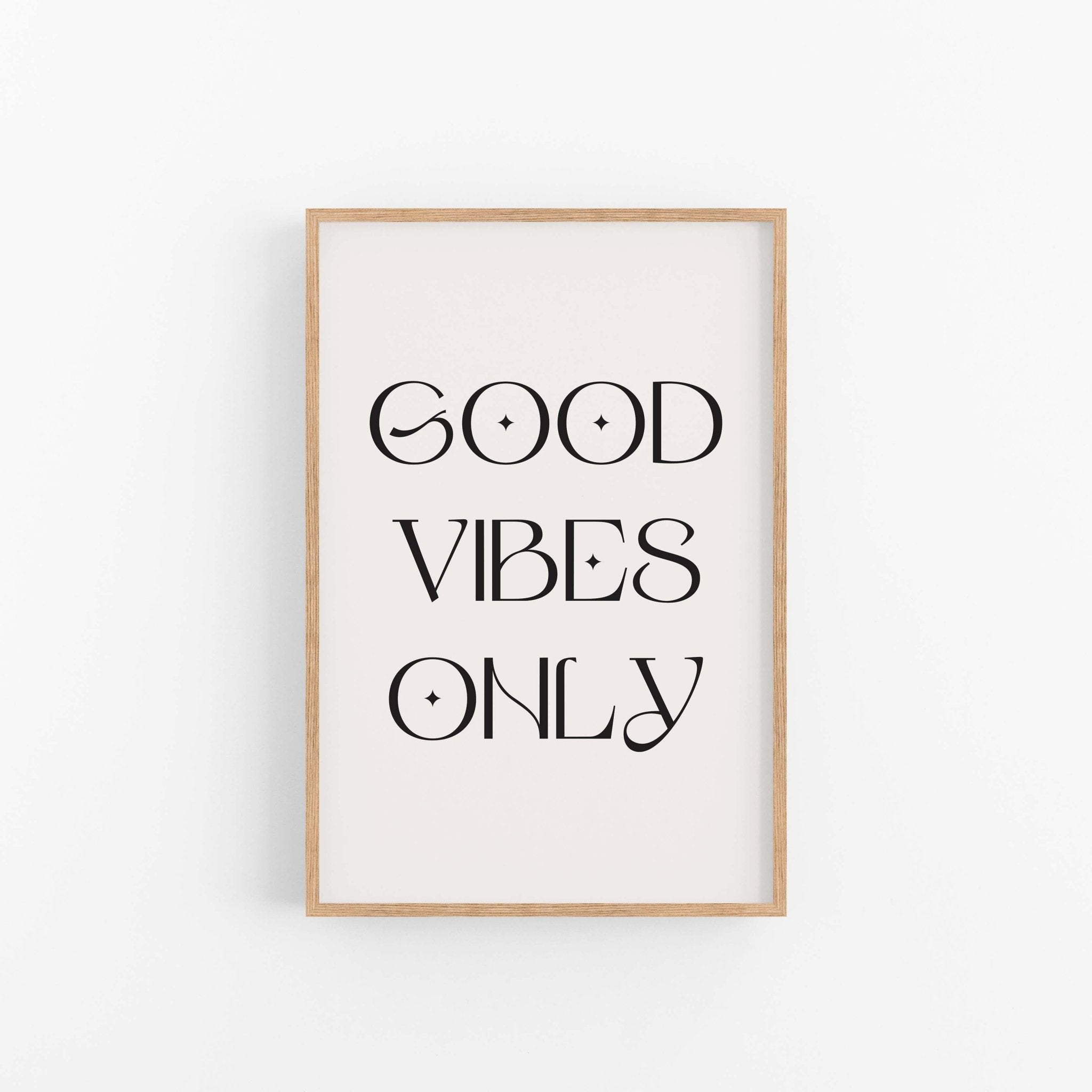 Good Vibes Only black typography wall art print on off-white background in light wood frame