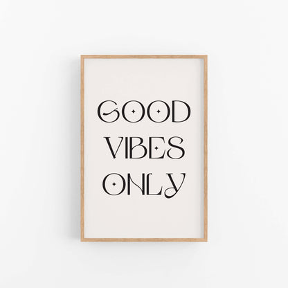 Good Vibes Only black typography wall art print on off-white background in light wood frame