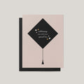 Grad Cap graduation greeting card by Blú Rose, blush card with black graduation cap illustration and celebrating you text, shown with black envelope