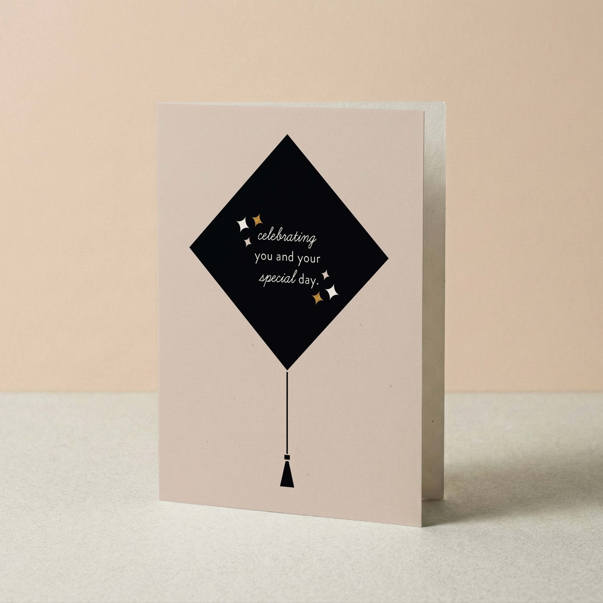 Grad Cap graduation card by Blú Rose standing upright, graduation cap illustration on a neutral background