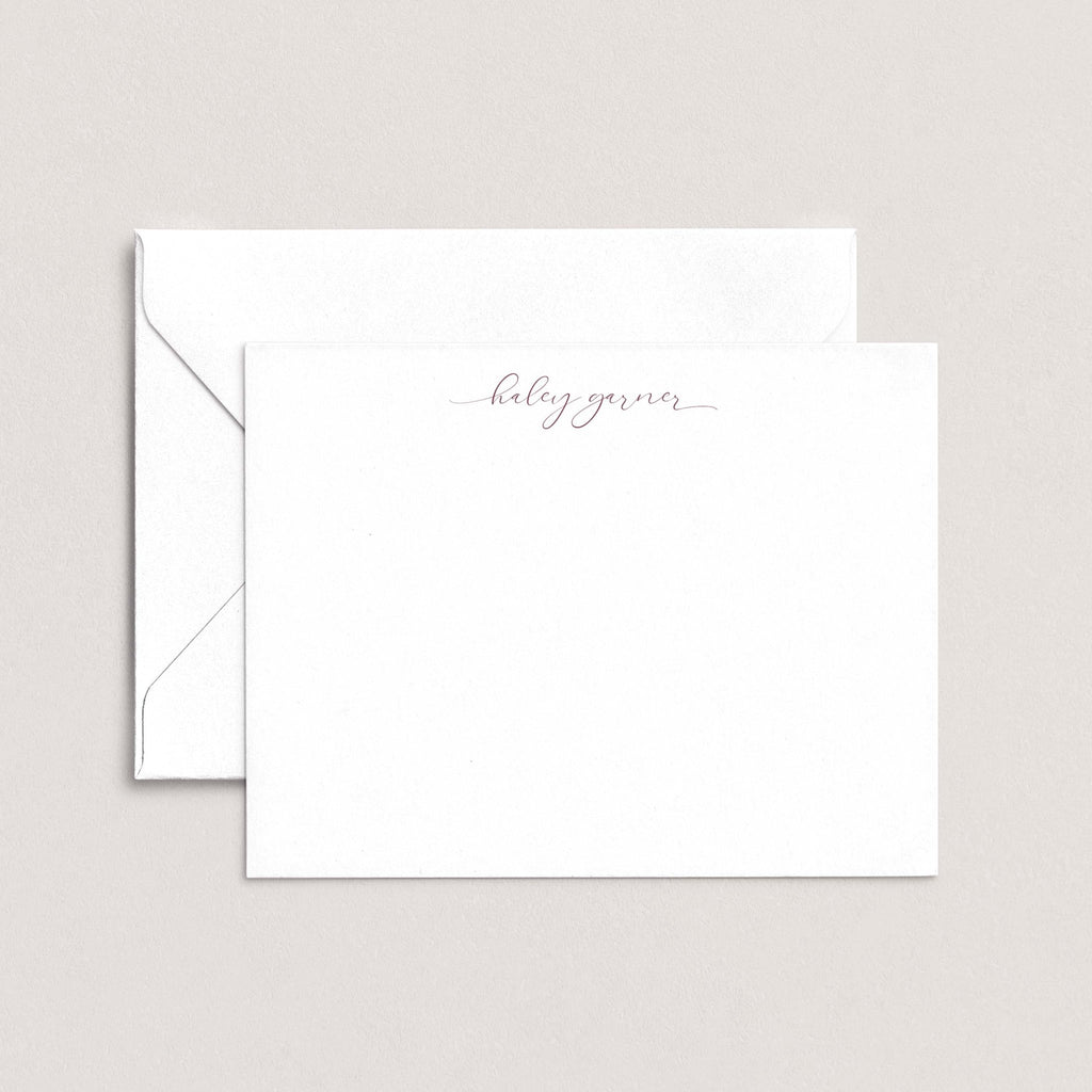 Haley personalized notecards by Blú Rose, white flat notecard with the name 'Haley Garner' in mauve script, shown with a coordinating white envelope
