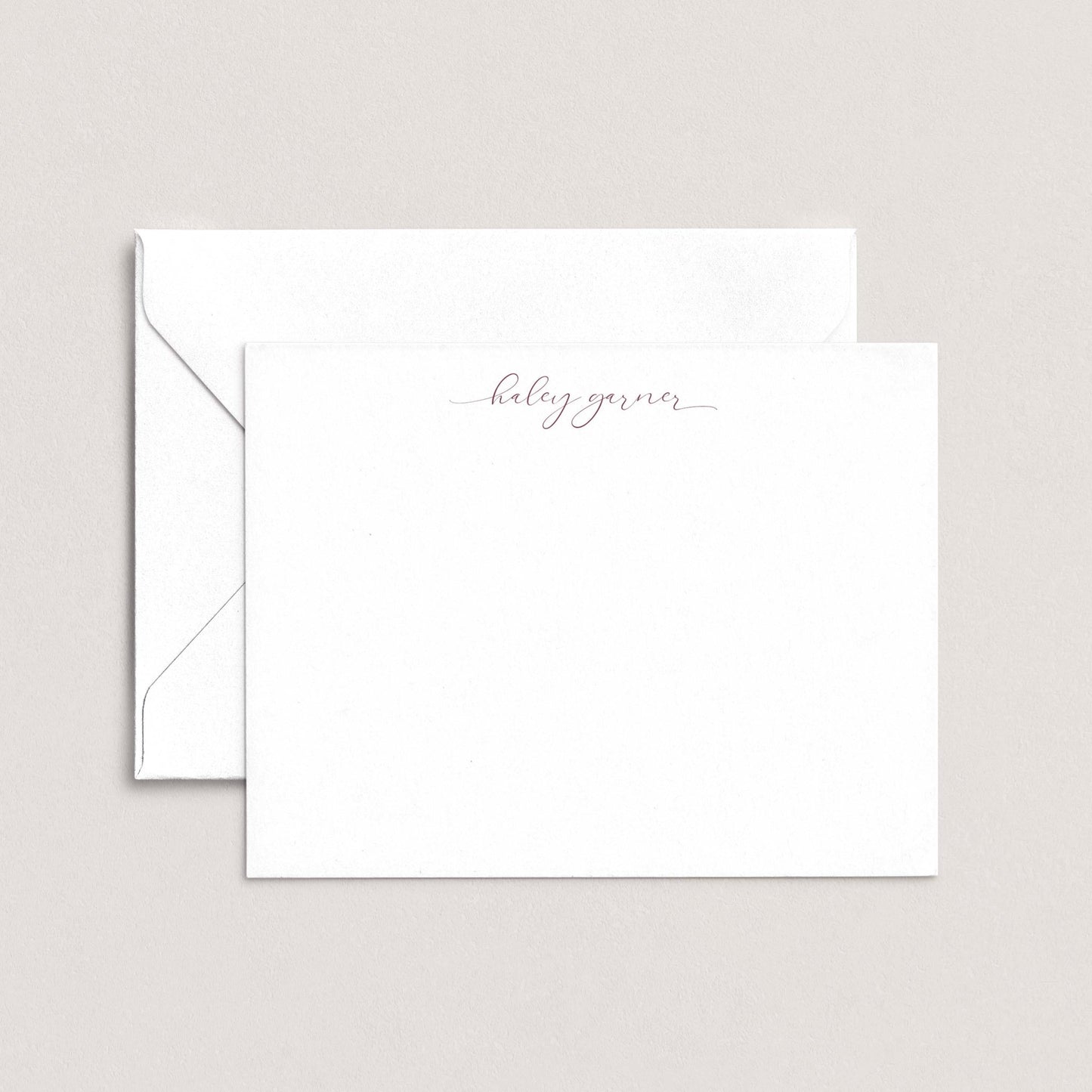 A white envelope with a personalized note inside, placed against a plain background.
