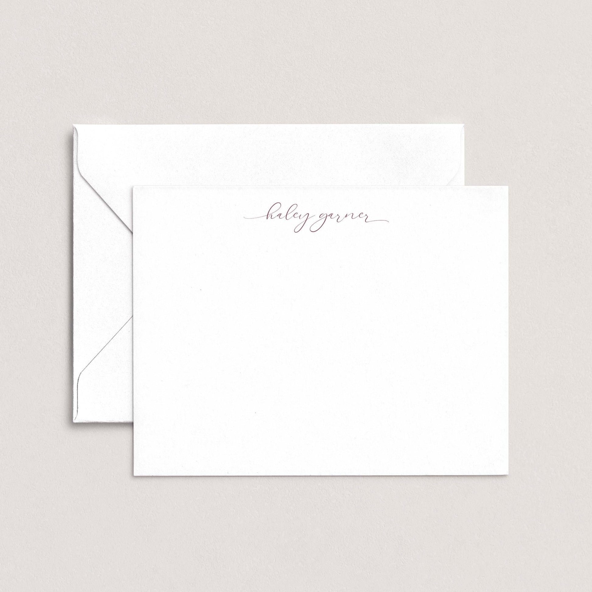 A white envelope with a personalized note inside, placed against a plain background.
