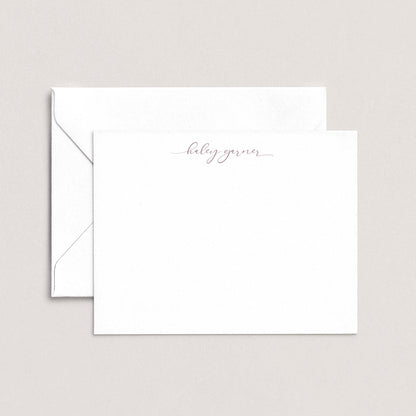 A white envelope with a personalized note inside, placed against a plain background.