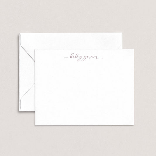A white envelope with a personalized note inside, placed against a plain background.