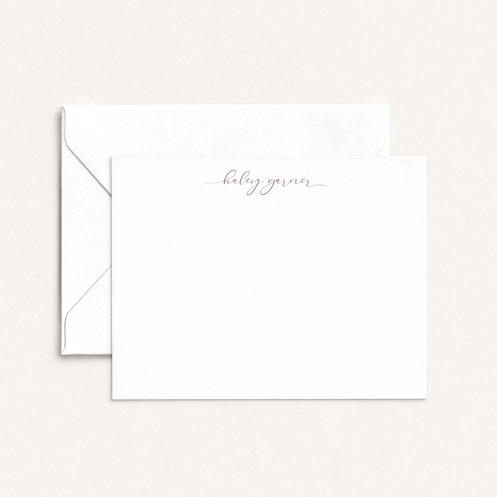 Haley personalized notecards by Blú Rose, white flat notecard with the name 'Haley Garner' in mauve script, shown with a white envelope