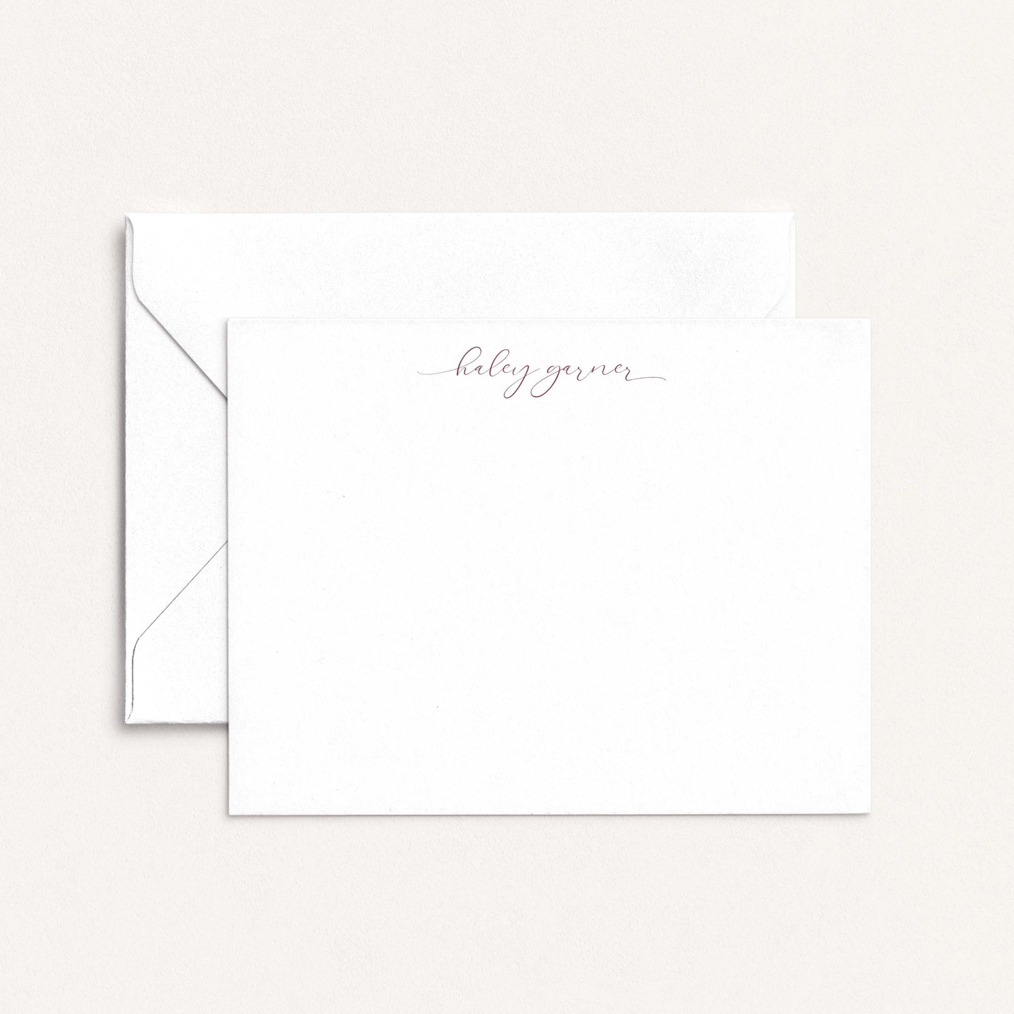 Haley personalized notecards by Blú Rose, white flat notecard with the name 'Haley Garner' in mauve script, shown with a white envelope