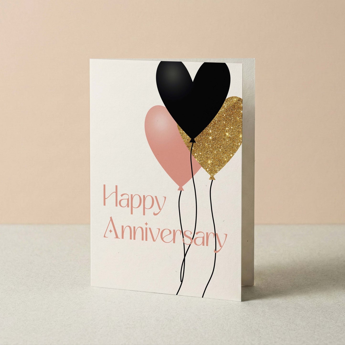 Greeting card with heart-shaped balloons and 'Happy Anniversary' text on a beige background