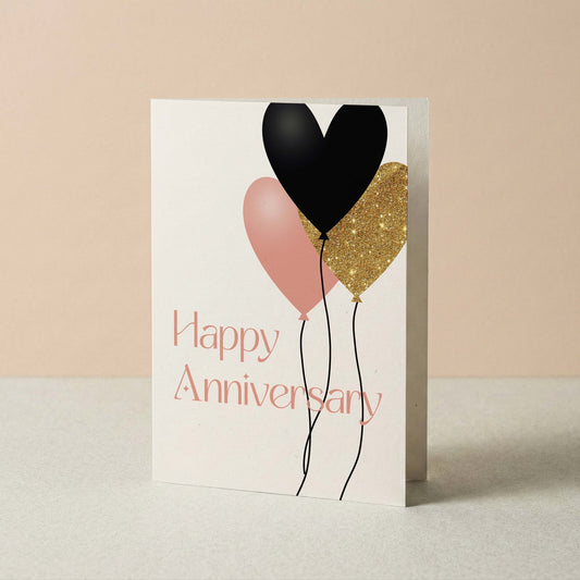 Greeting card with heart-shaped balloons and 'Happy Anniversary' text on a beige background