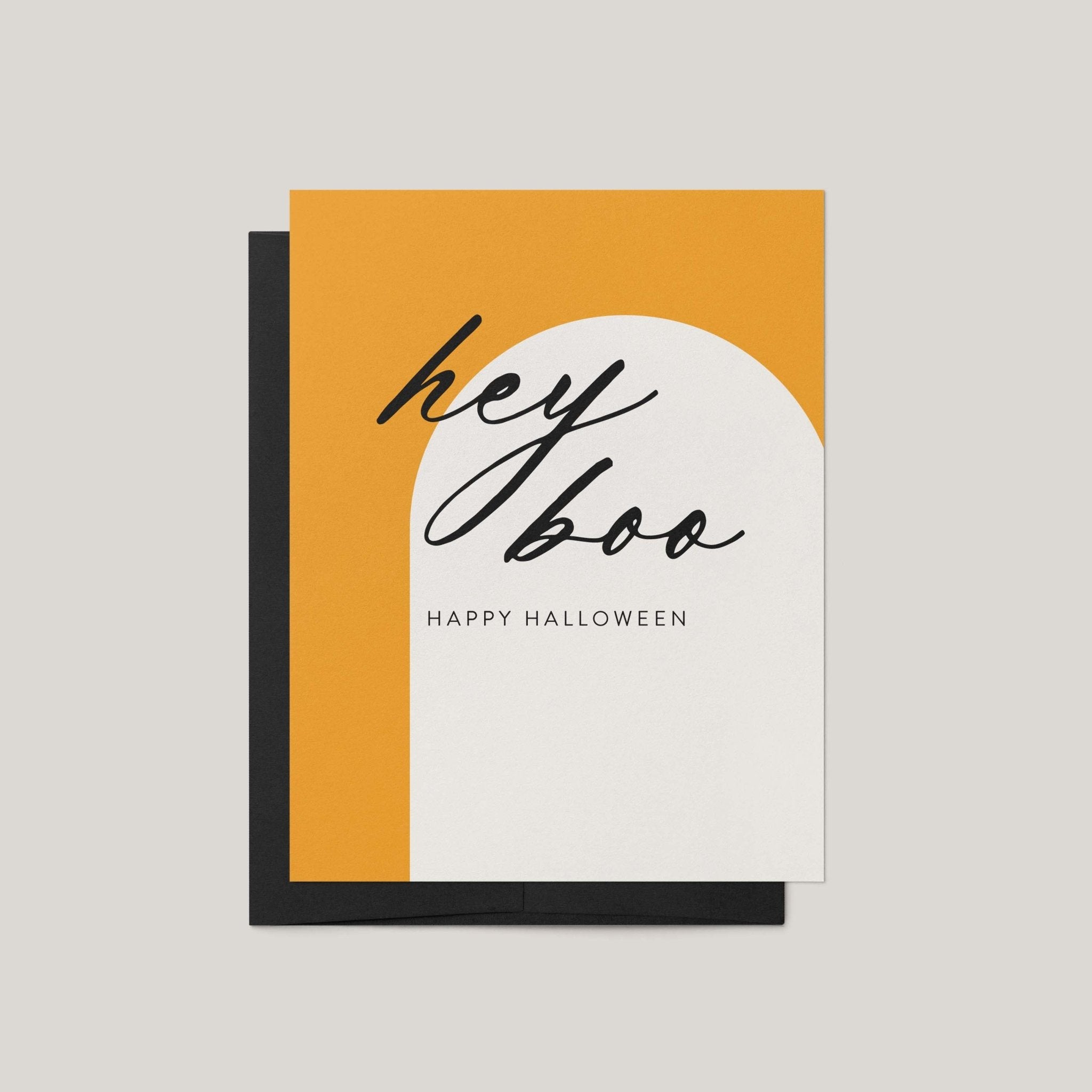 Hey Boo Halloween greeting card by Blú Rose, marigold and white arch card with black script hey boo text, shown with black envelope