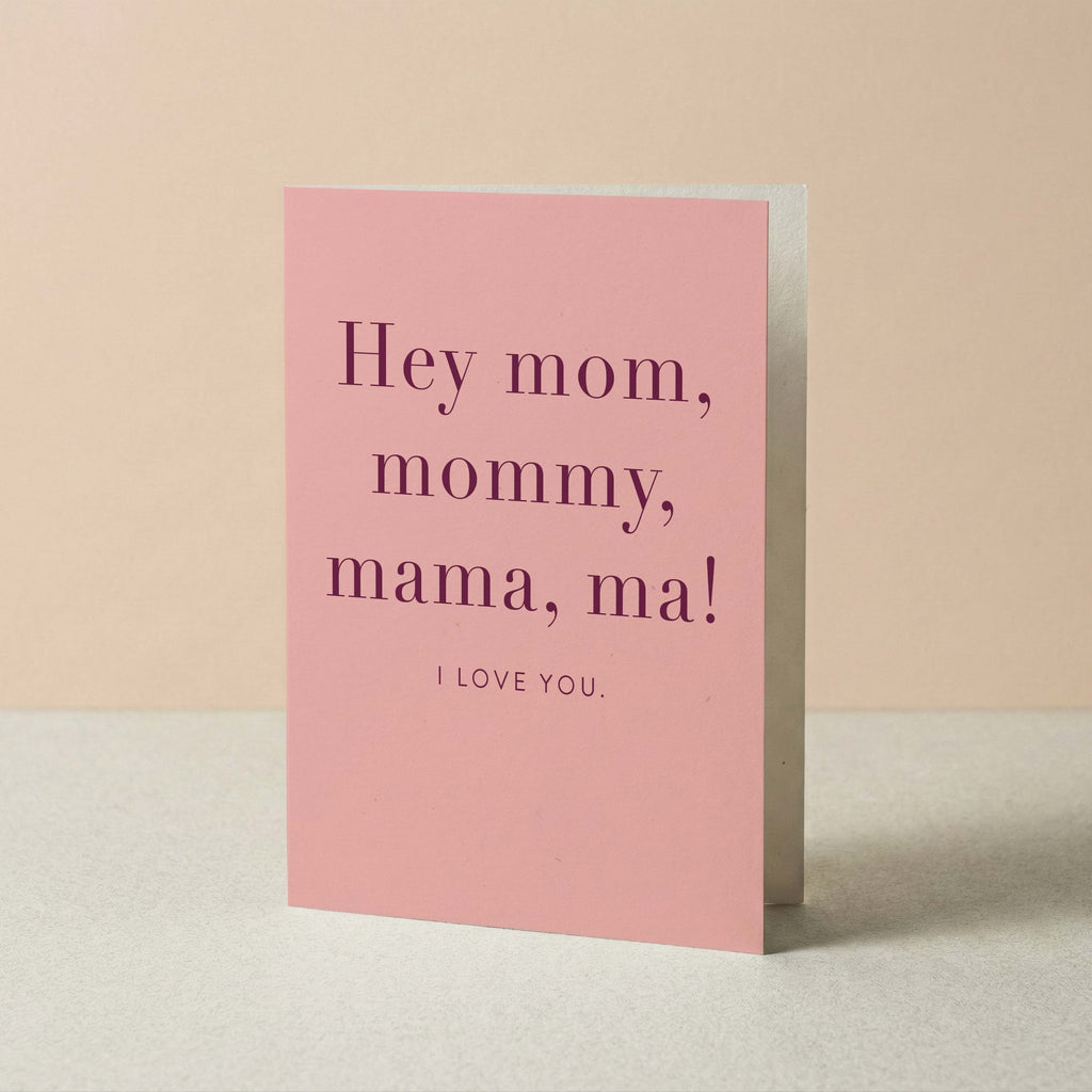 Hey Mom card by Blú Rose standing upright, pink card with plum typography on a neutral background