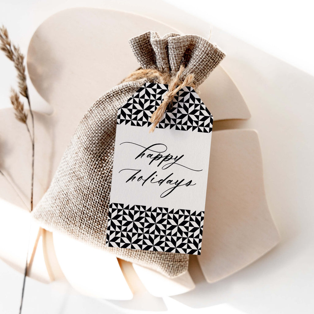 Holiday Pattern gift tag by Blú Rose, 'happy holidays' script tag with black and white geometric borders on a burlap favor bag