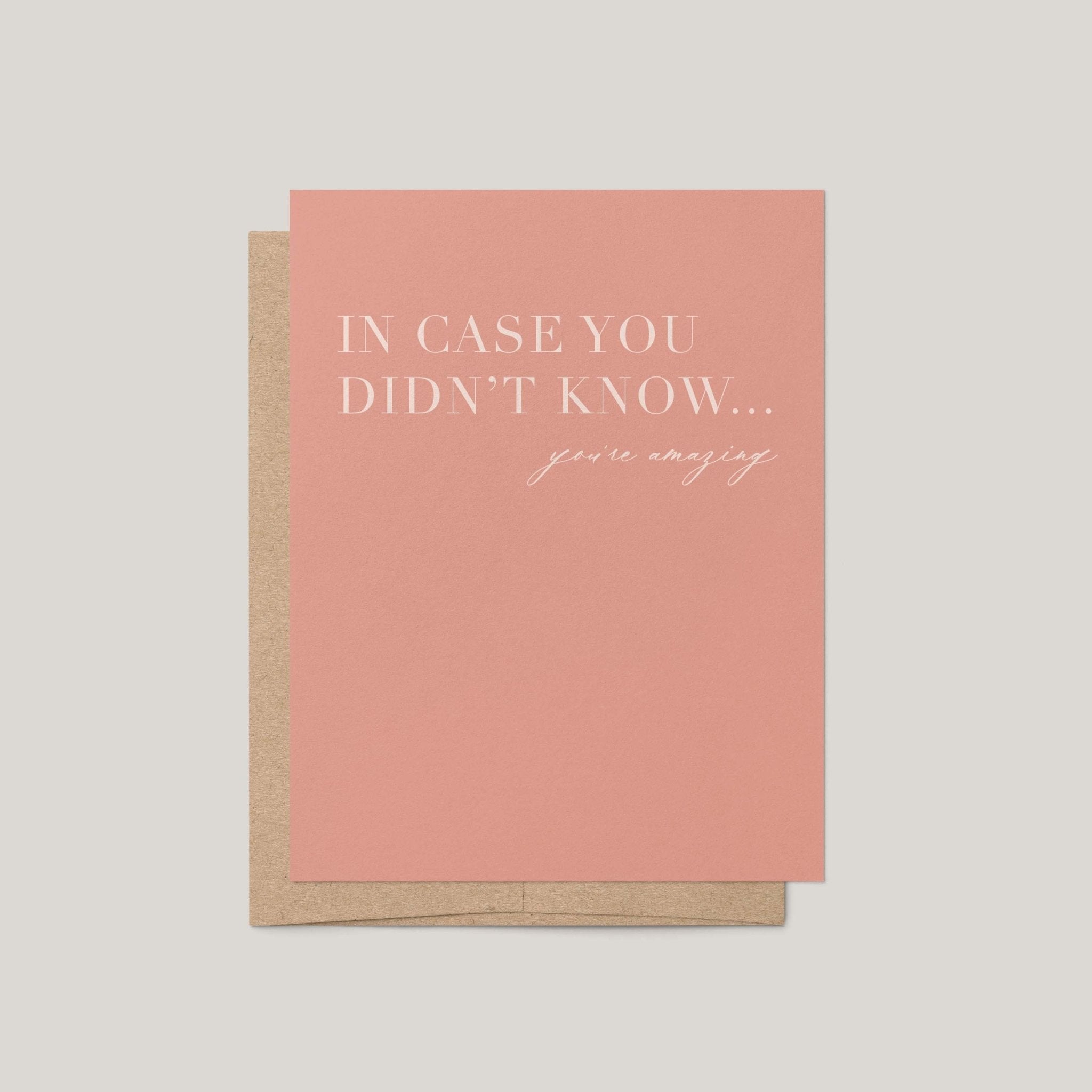 A pink greeting card with white text reading 'IN CASE YOU DIDN'T KNOW... you're amazing.