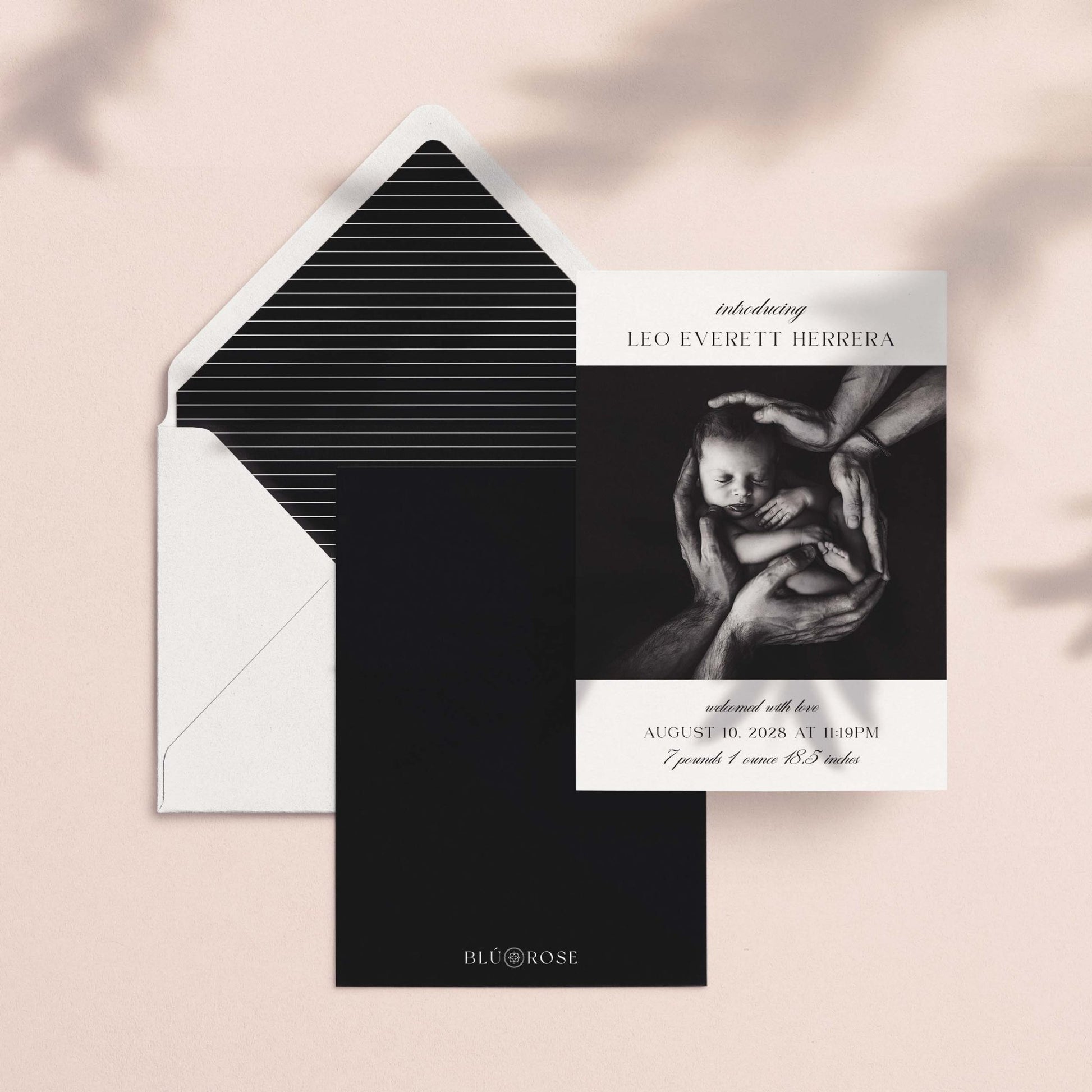 Introducing Me birth announcement card shown with black striped envelope liner and dark backer card on blush background