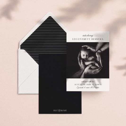 Introducing Me birth announcement card shown with black striped envelope liner and dark backer card on blush background