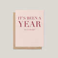It's Been a Year Thanksgiving greeting card by Blú Rose, blush card with burgundy serif text, shown with kraft envelope