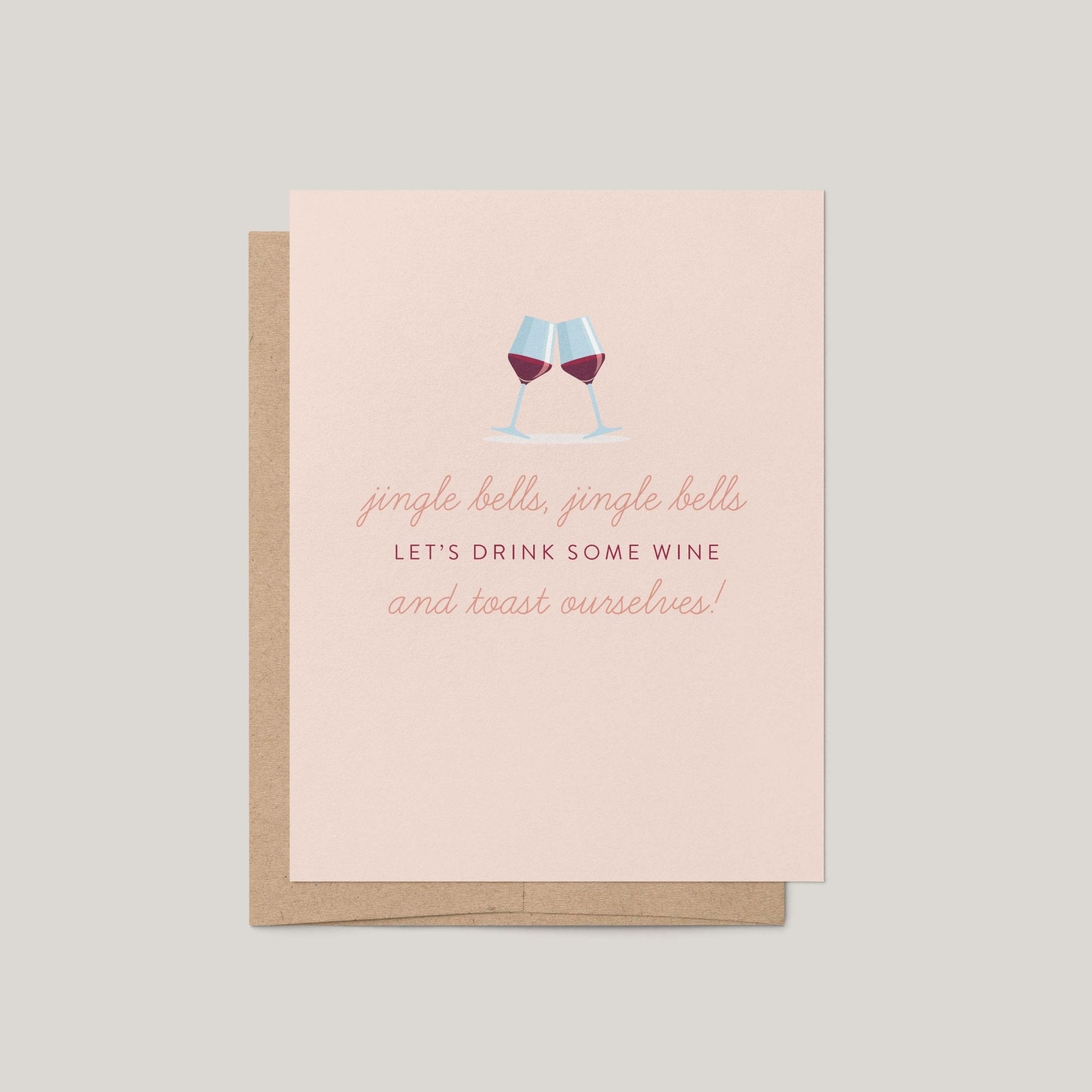 Jingle Bells & Wine funny holiday greeting card by Blú Rose, blush card with clinking red wine glasses illustration, shown with kraft envelope