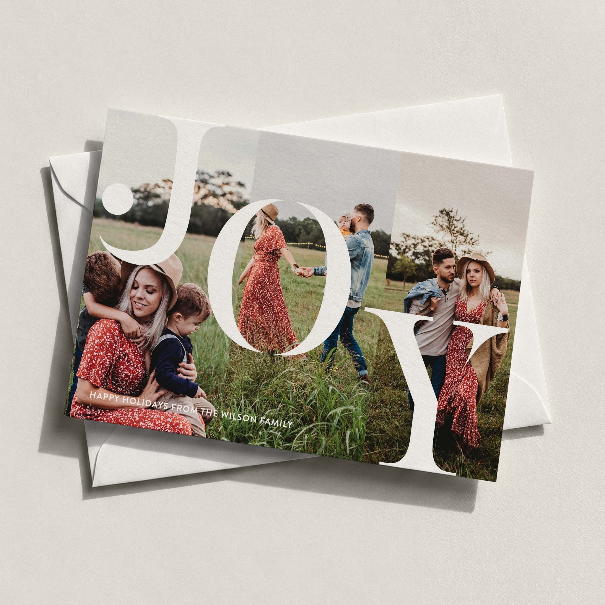 Joy landscape photo card spelling JOY in white over a three-photo family collage