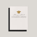 Knew You Could Do It graduation greeting card by Blú Rose, ivory card with gold graduation cap and congratulations text, shown with black envelope