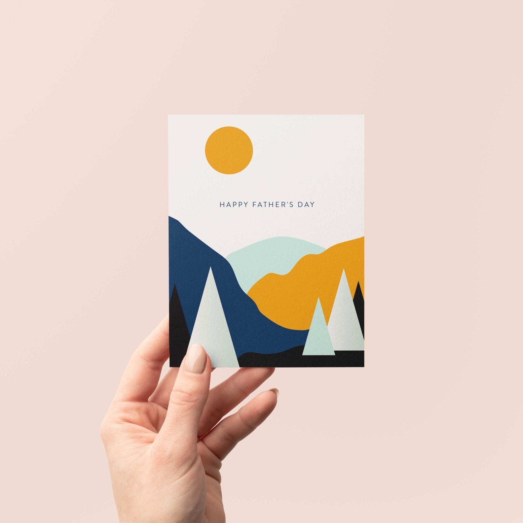 Landscape Father's Day greeting card by Blú Rose held in hand against a neutral off-white background