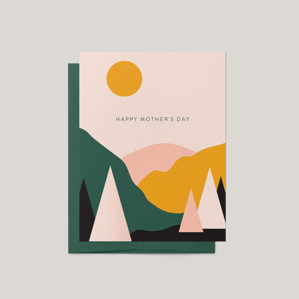 A Mother's Day greeting card with a minimalist geometric landscape design, featuring a yellow sun, pink and yellow mountains, and dark green hills under the text 'HAPPY MOTHER'S DAY'.