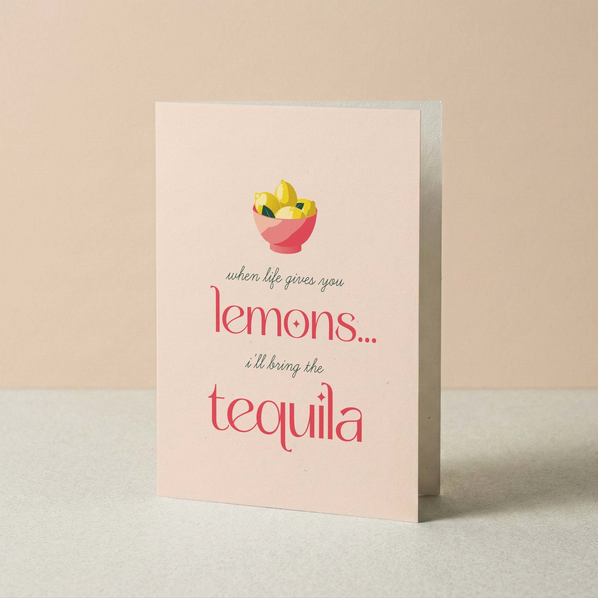Lemons + Tequila funny greeting card by Blú Rose standing upright, blush card with lemons illustration on a neutral background