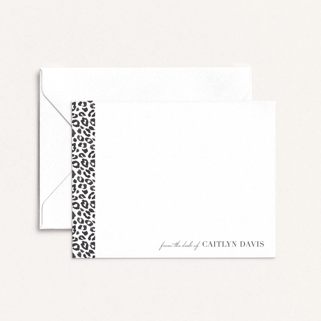 Leopard personalized notecards by Blú Rose, white flat notecard with a leopard-print side stripe and 'from the desk of Caitlyn Davis', shown with a white envelope