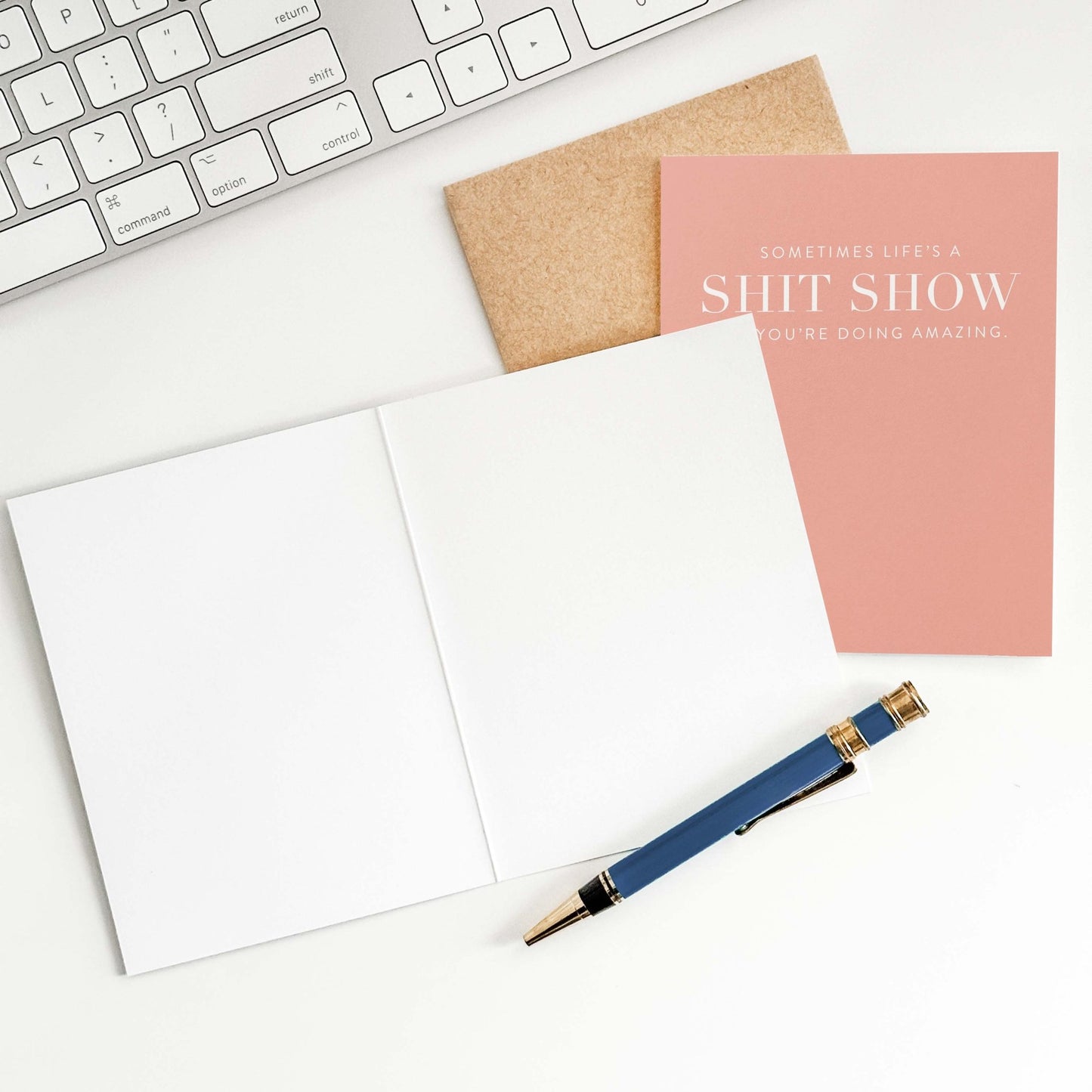 Funny encouragement greeting card on desk with open card and envelope