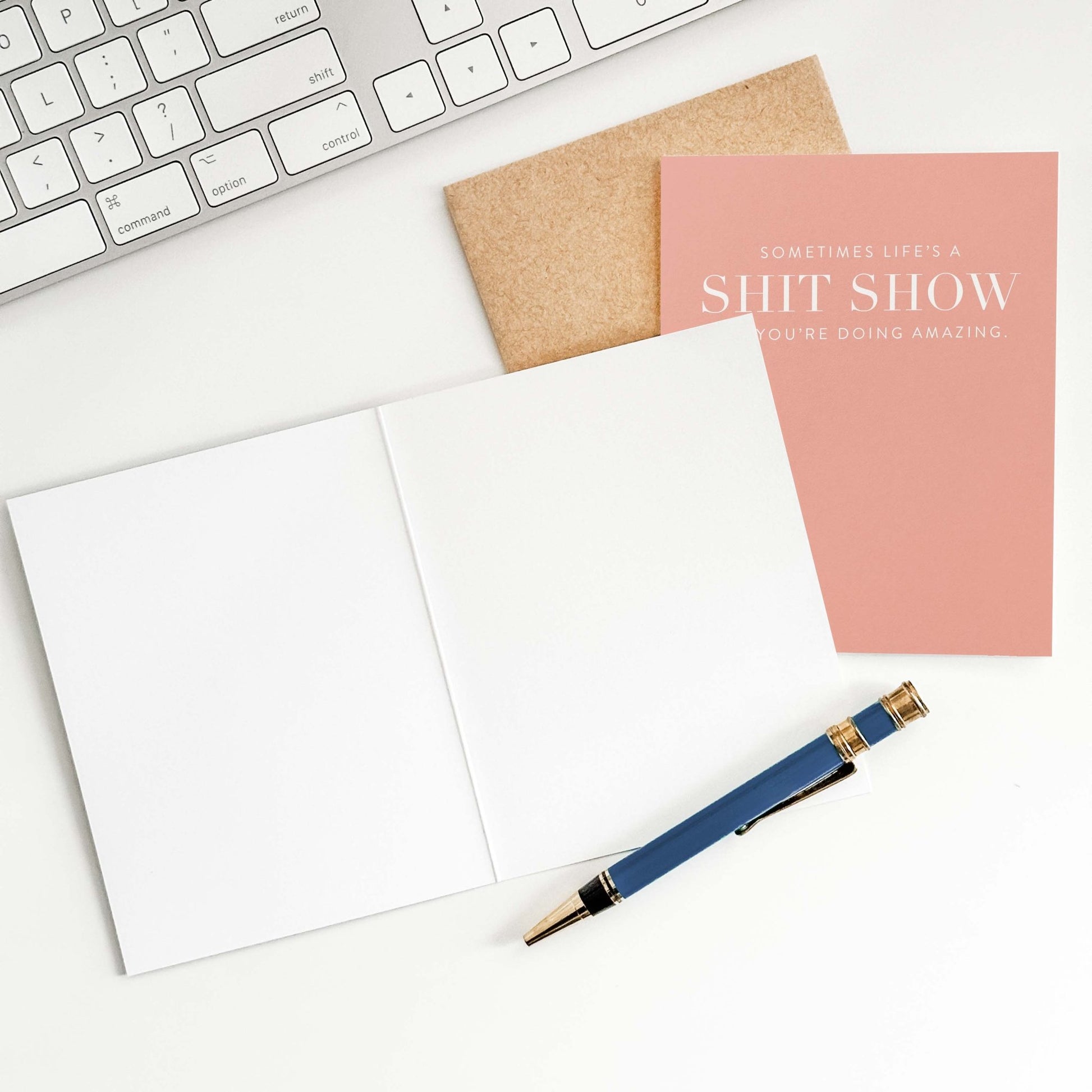 Funny encouragement greeting card on desk with open card and envelope