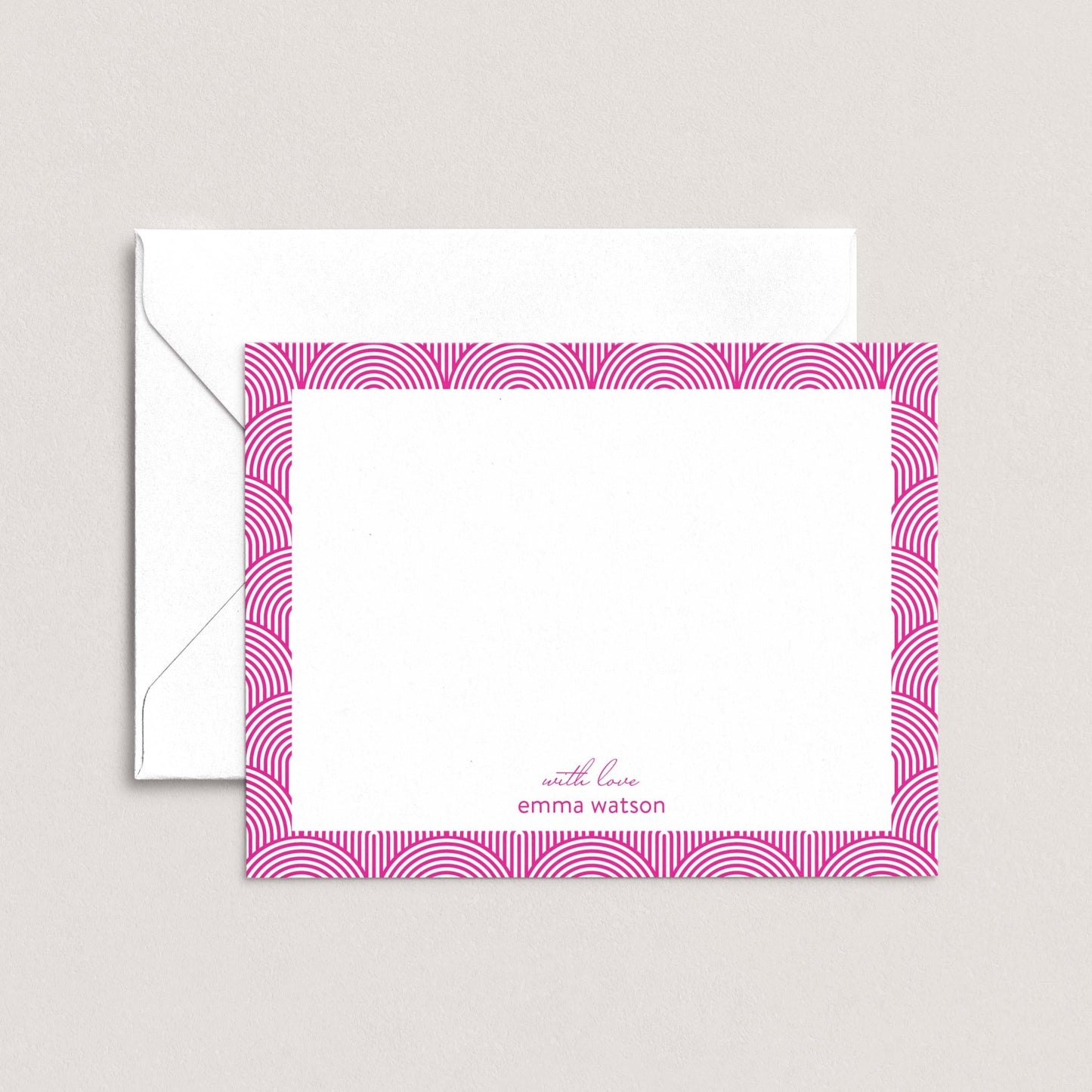 a white envelope with a pink frame and a blank white card with a pink border.