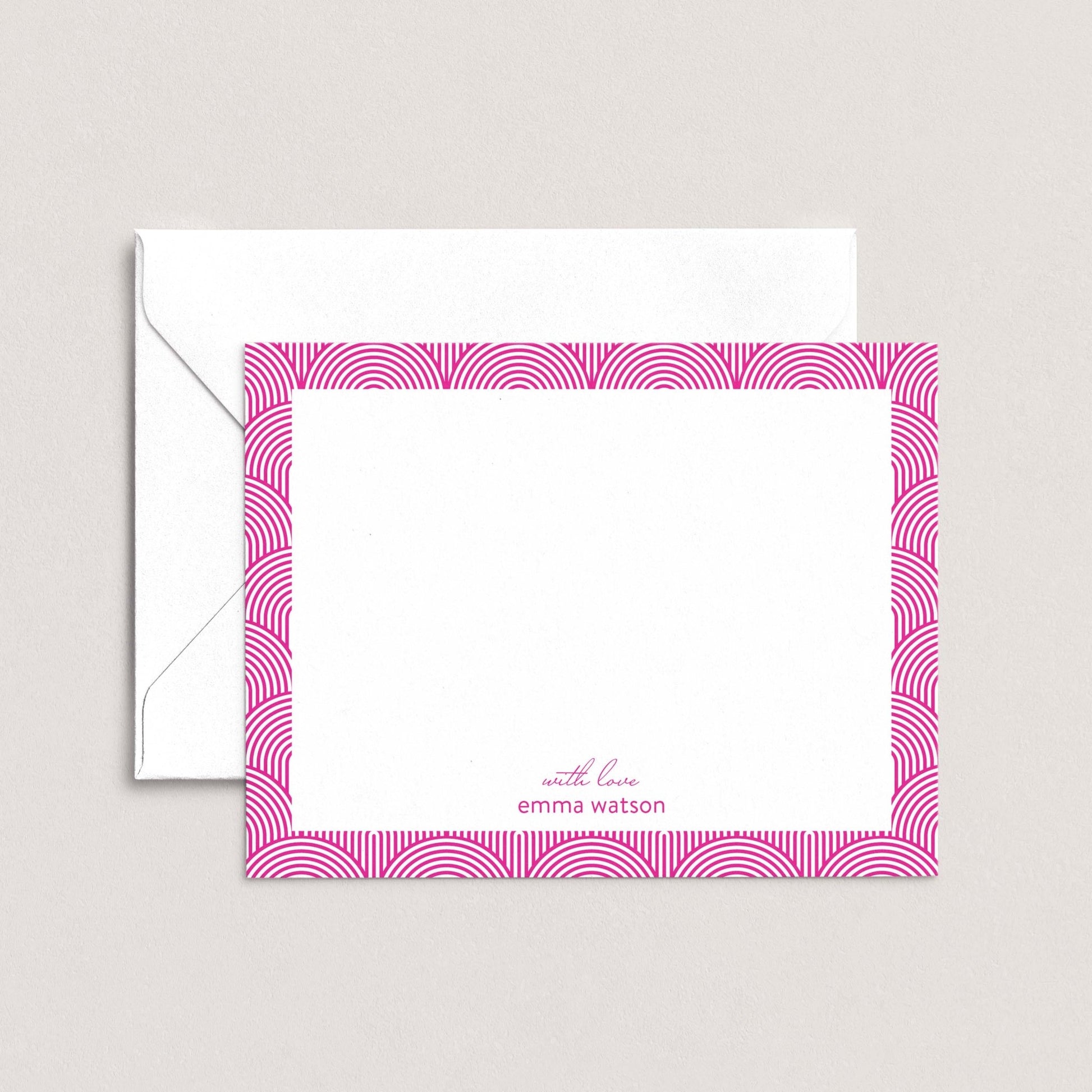 a white envelope with a pink frame and a blank white card with a pink border.