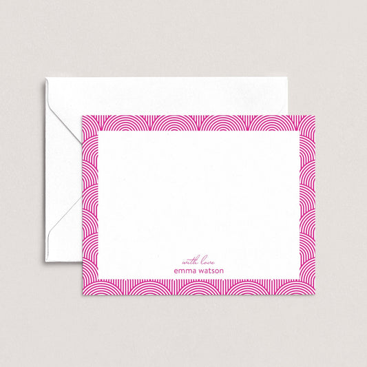 a white envelope with a pink frame and a blank white card with a pink border.