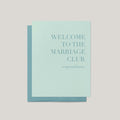 A mint green 'Welcome to the Marriage Club' congratulations card with a matching blue envelope, displayed on a neutral light gray background.