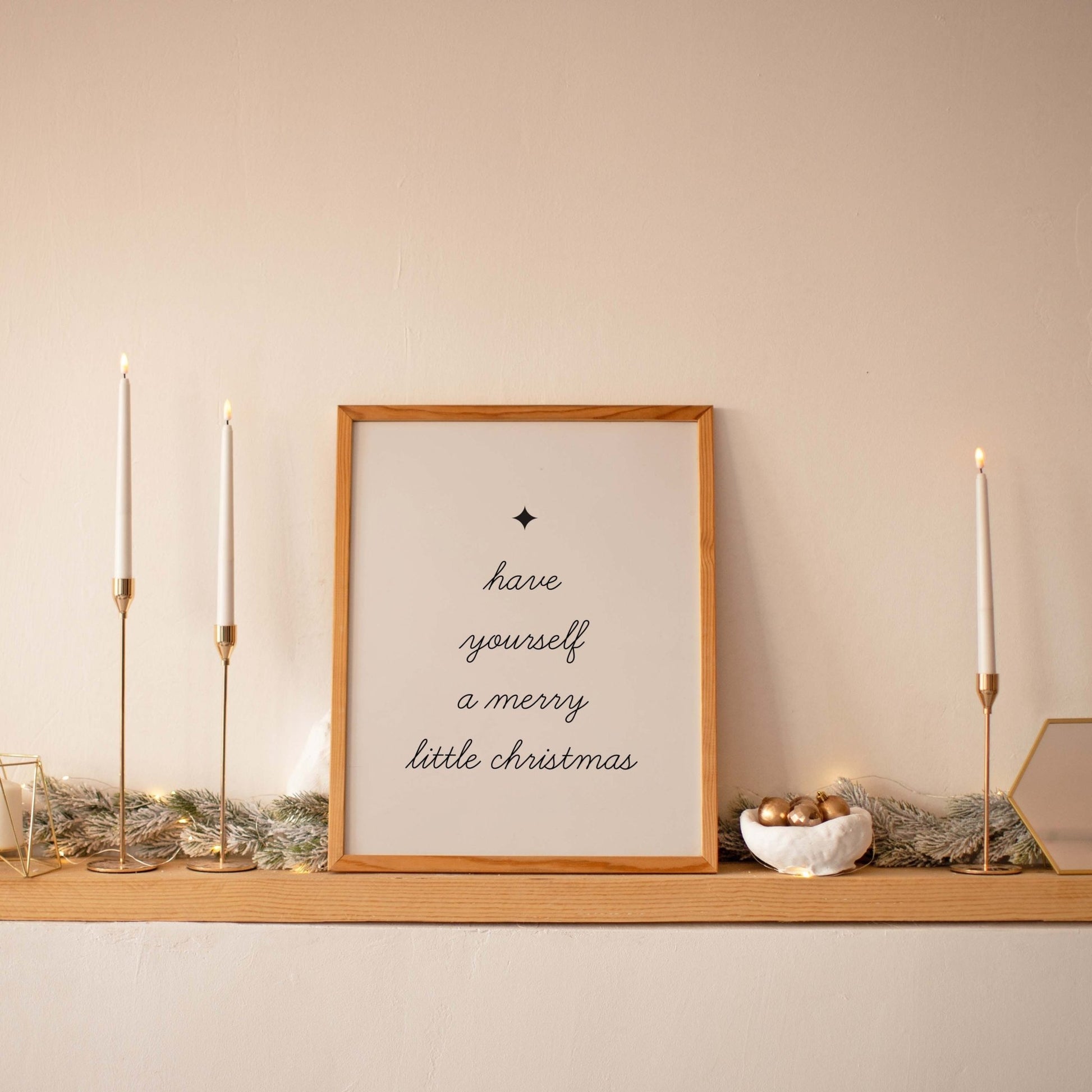 Decorative shelf with candles, a framed print, and small objects against a beige wall.