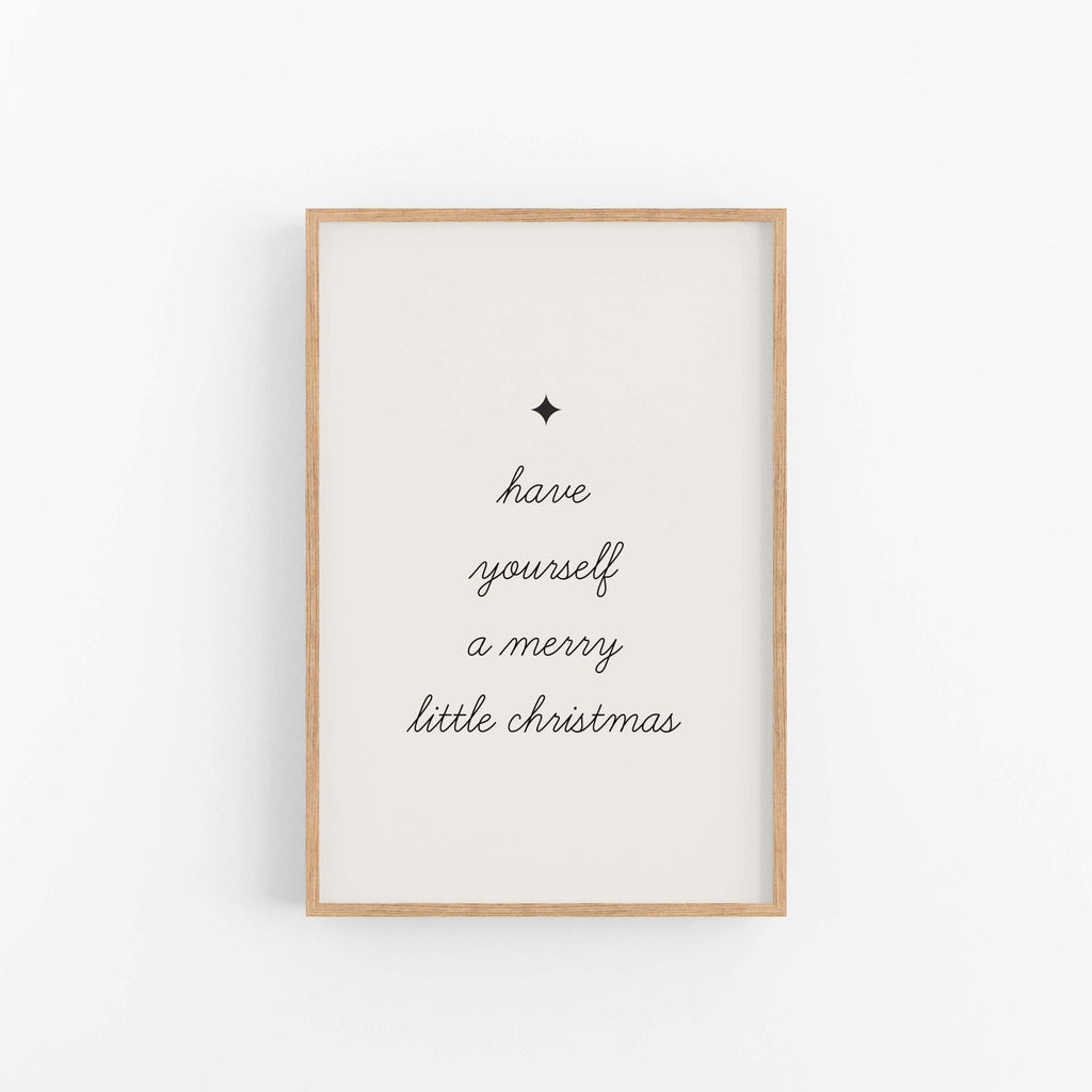 Framed artwork with 'have yourself a merry little Christmas' text on a white background